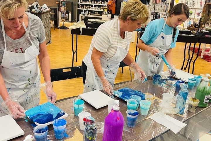 a group of people standing around a table
