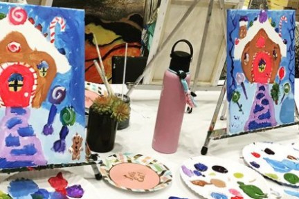 a person sitting at a table with a birthday cake