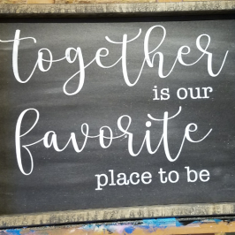 a blackboard sign on the side of a building